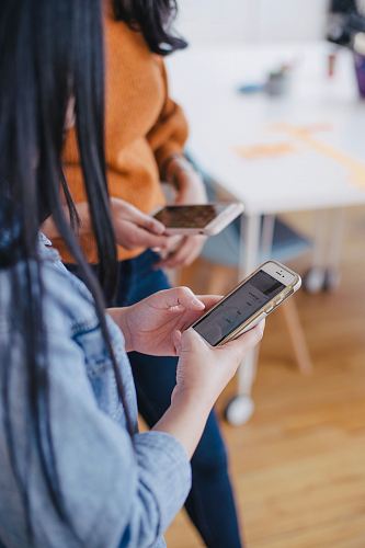 selective focus photography of woman holding phone